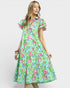 Woman wearing a colorful floral dress on a white background