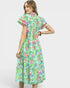 Woman wearing a colorful floral dress on a white background