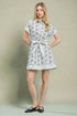 Woman wearing a floral dress against a plain background