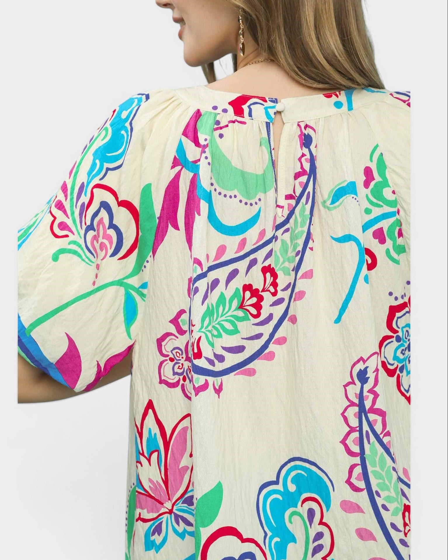 Colorful floral patterned dress on a plain background