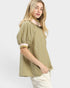 Woman wearing a green and white striped blouse on a white background