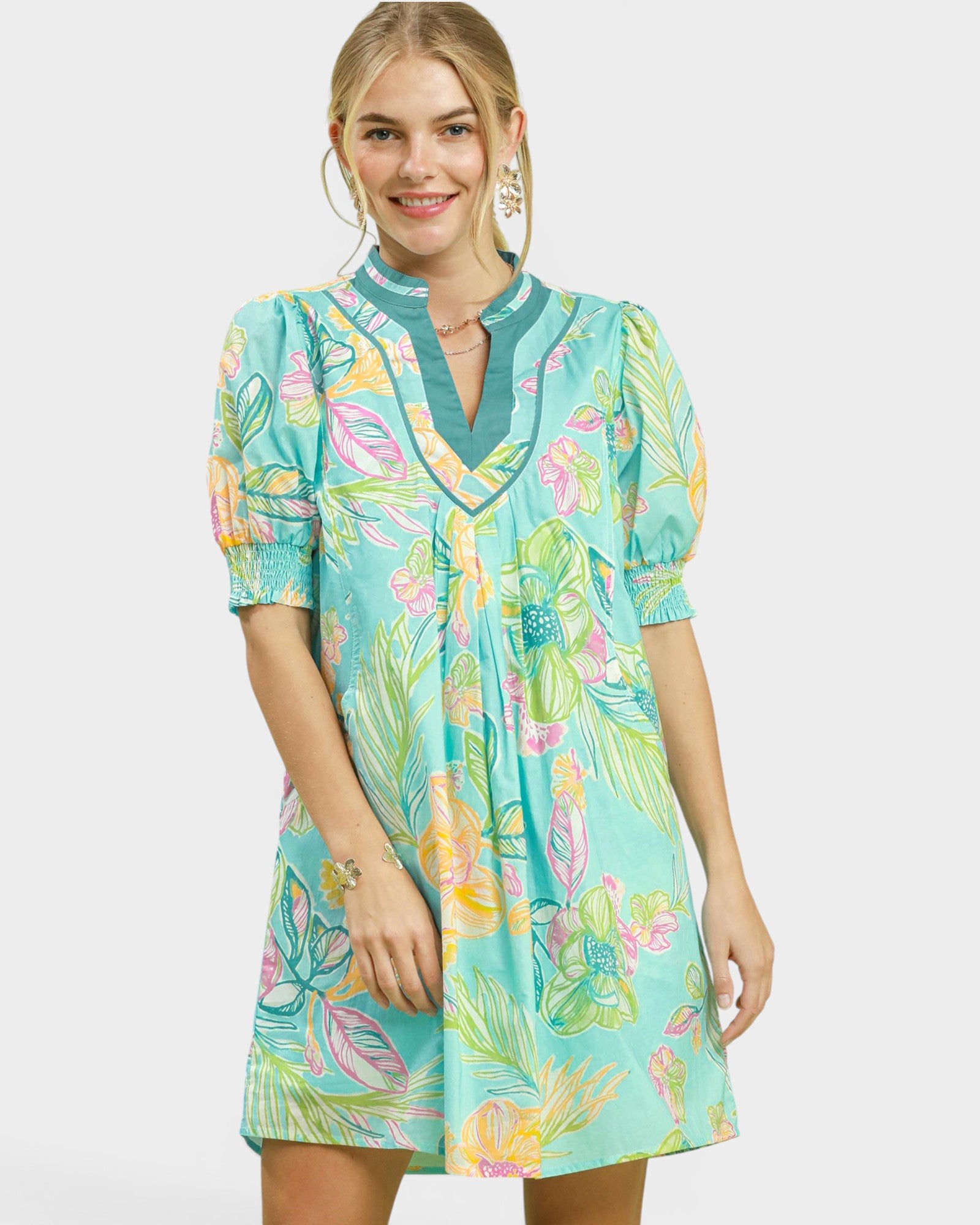 Woman wearing a colorful floral dress on a white background