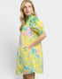Woman wearing a yellow floral dress on a white background