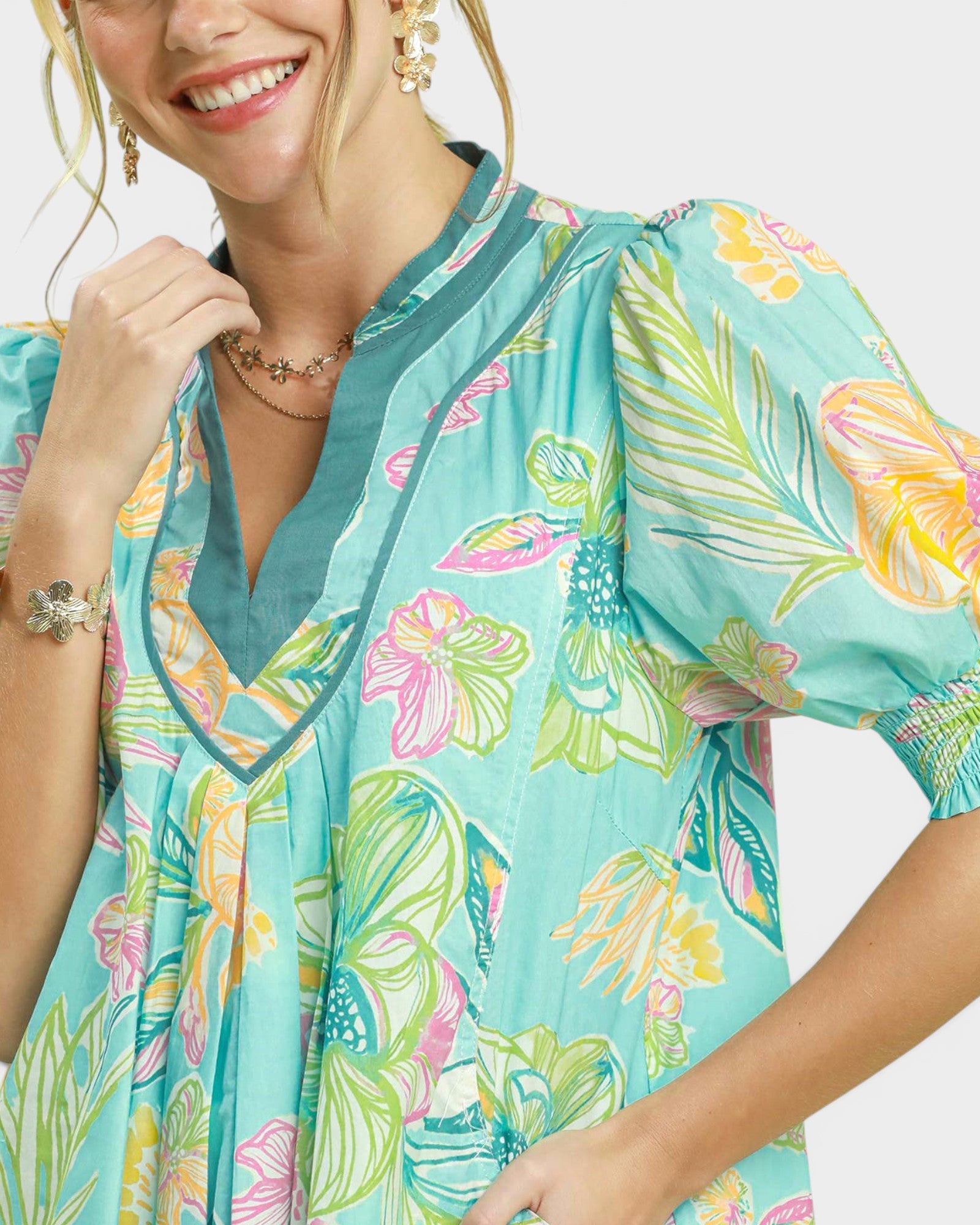 Woman wearing a colorful floral dress with a white background