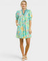 Woman wearing a colorful floral dress on a white background