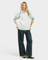 Woman wearing a striped shirt and dark pants on a white background