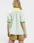 Person wearing a light green striped shirt with yellow accents on a white background