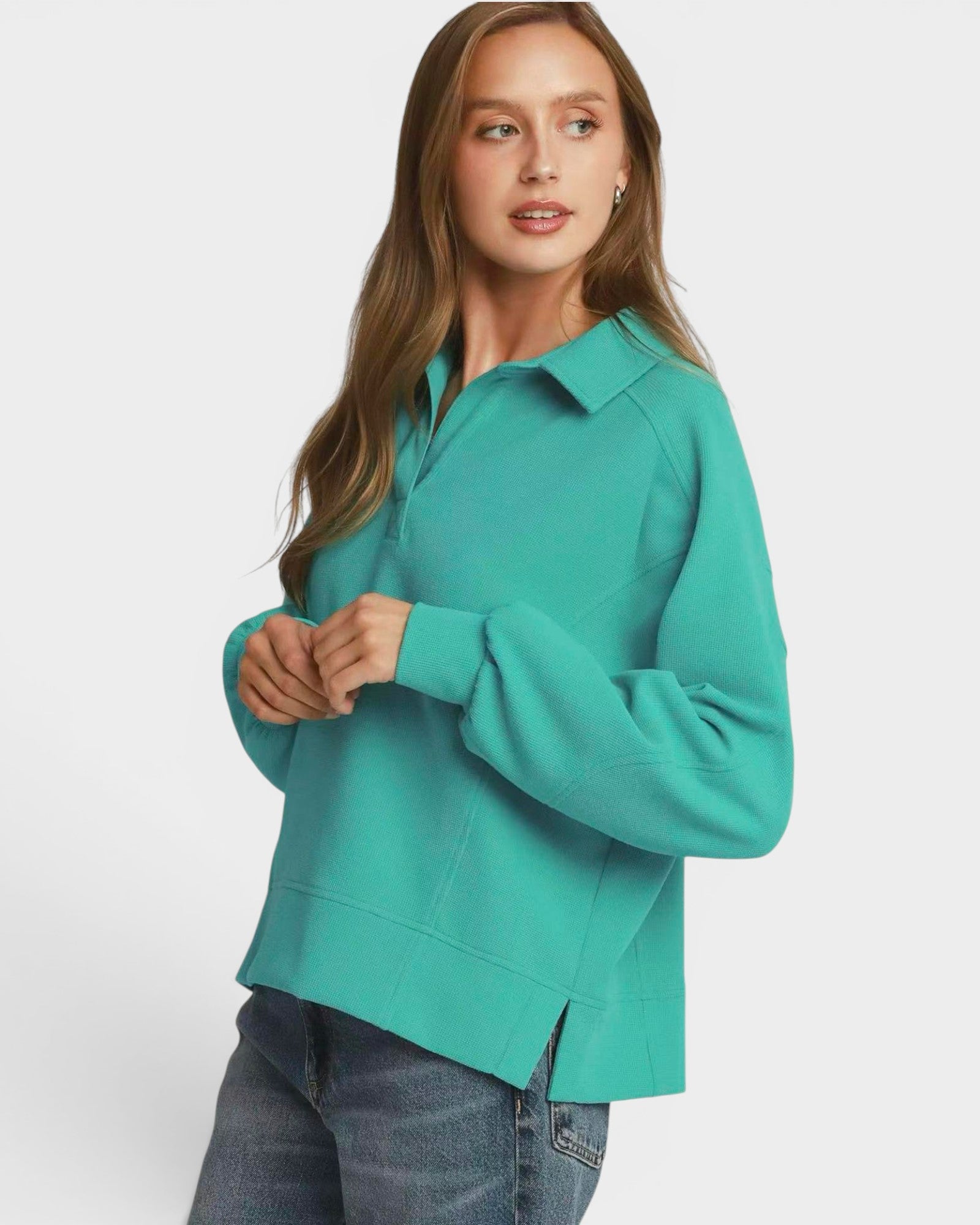Person wearing a teal sweatshirt on a white background