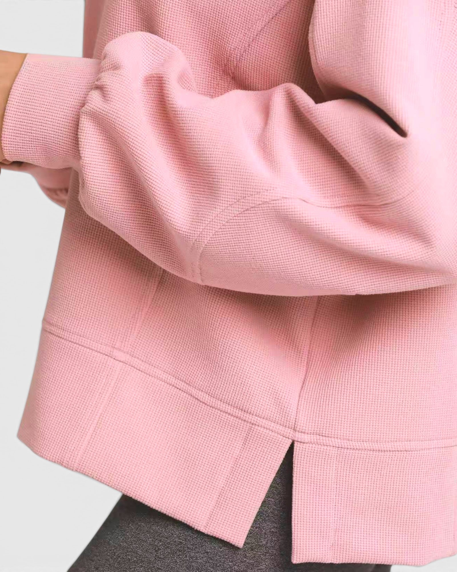 Close-up of a pink textured sweatshirt on a white background