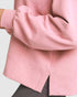 Close-up of a pink textured sweatshirt on a white background