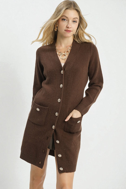 Woman wearing a brown cardigan with buttons on a white background