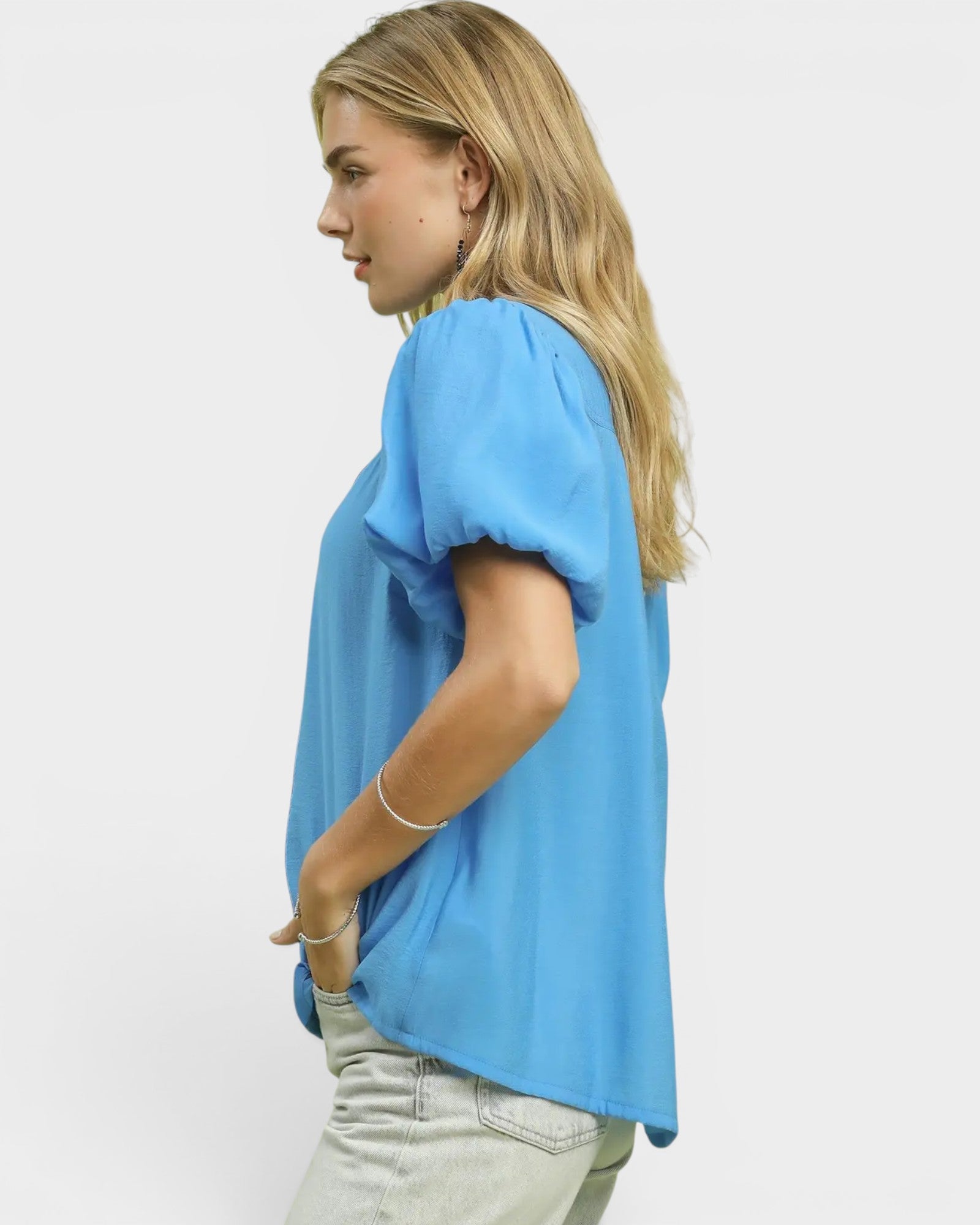 Woman wearing a light blue t-shirt on a white background