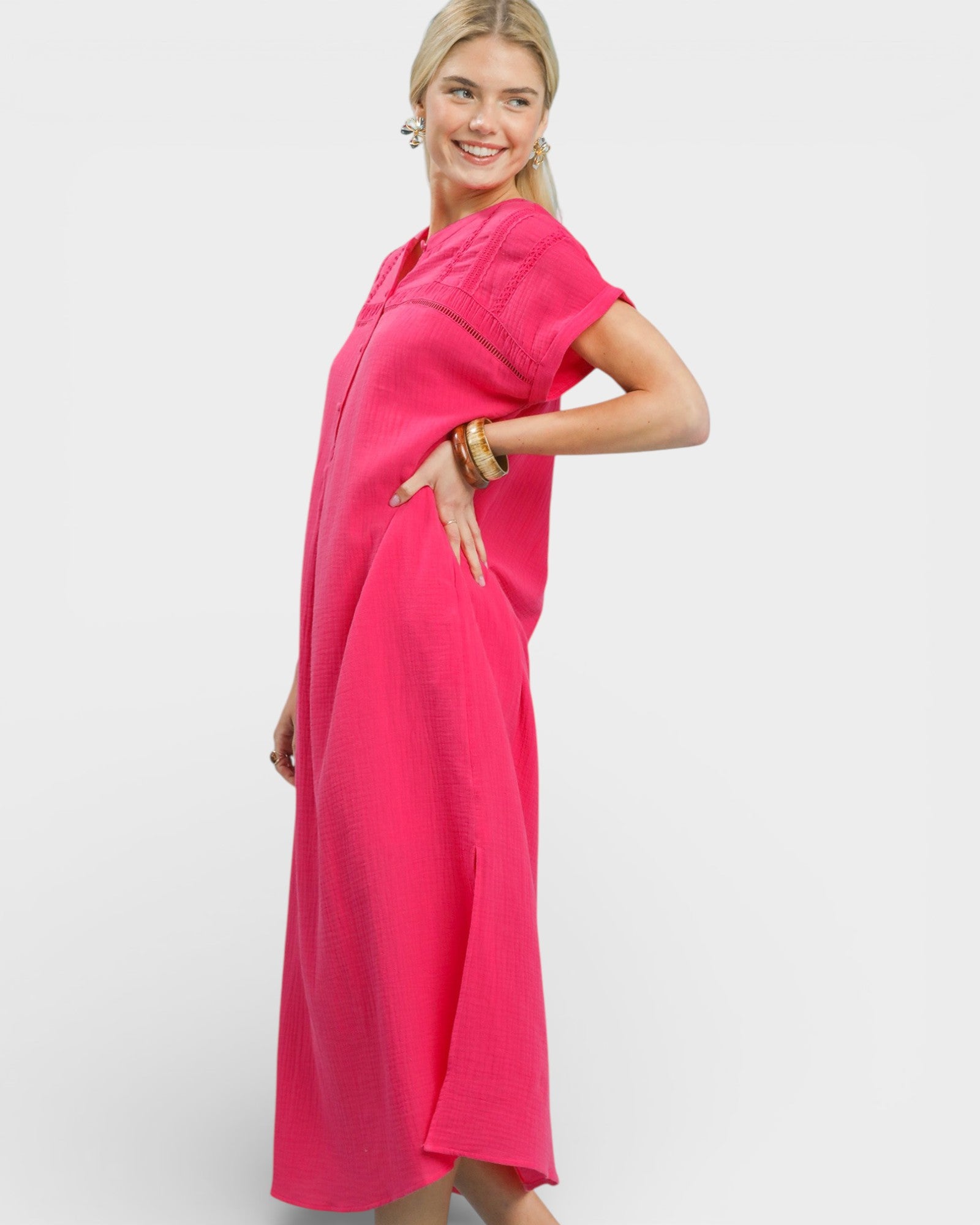 Woman wearing a bright pink dress on a white background