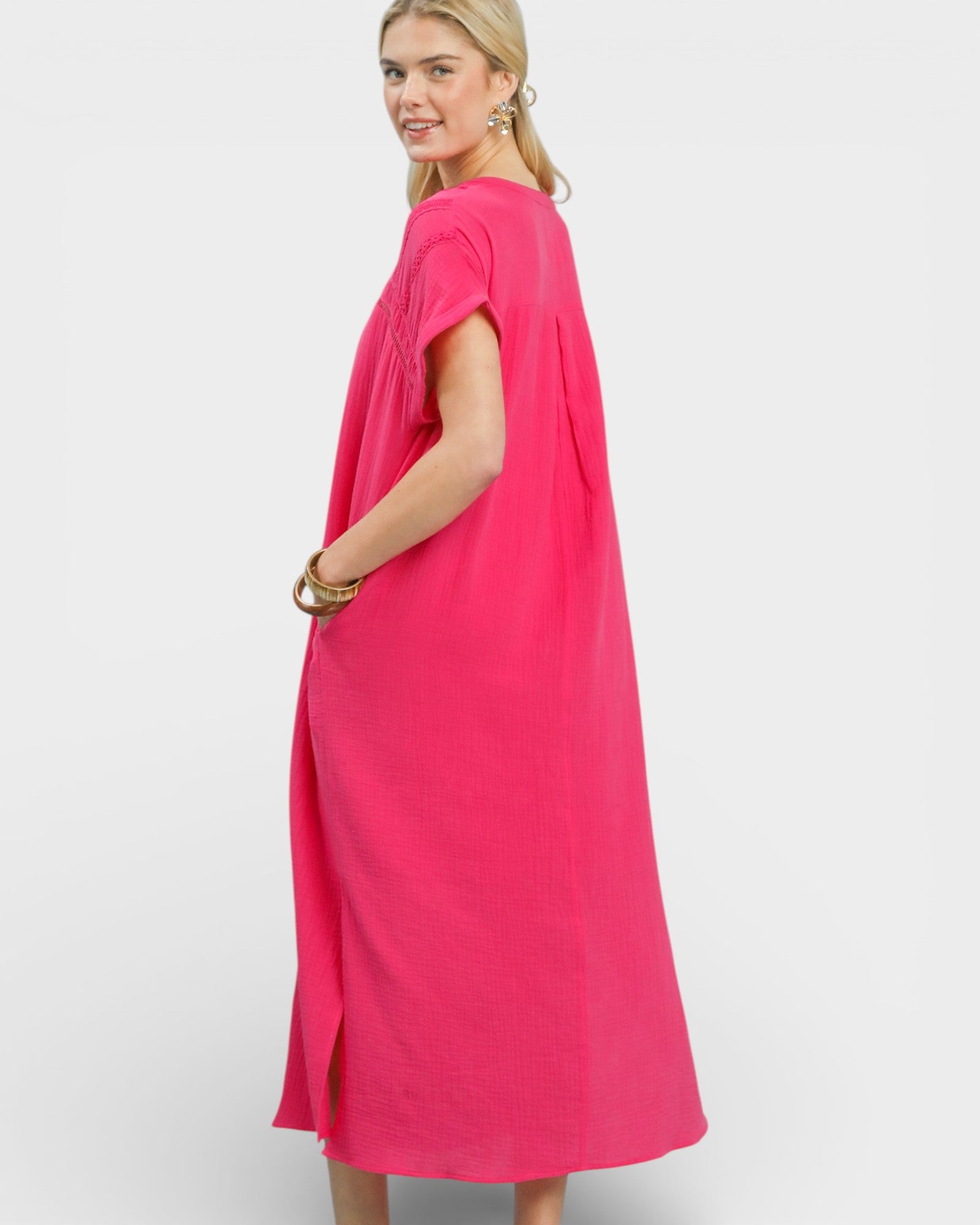 Woman wearing a bright pink dress on a white background