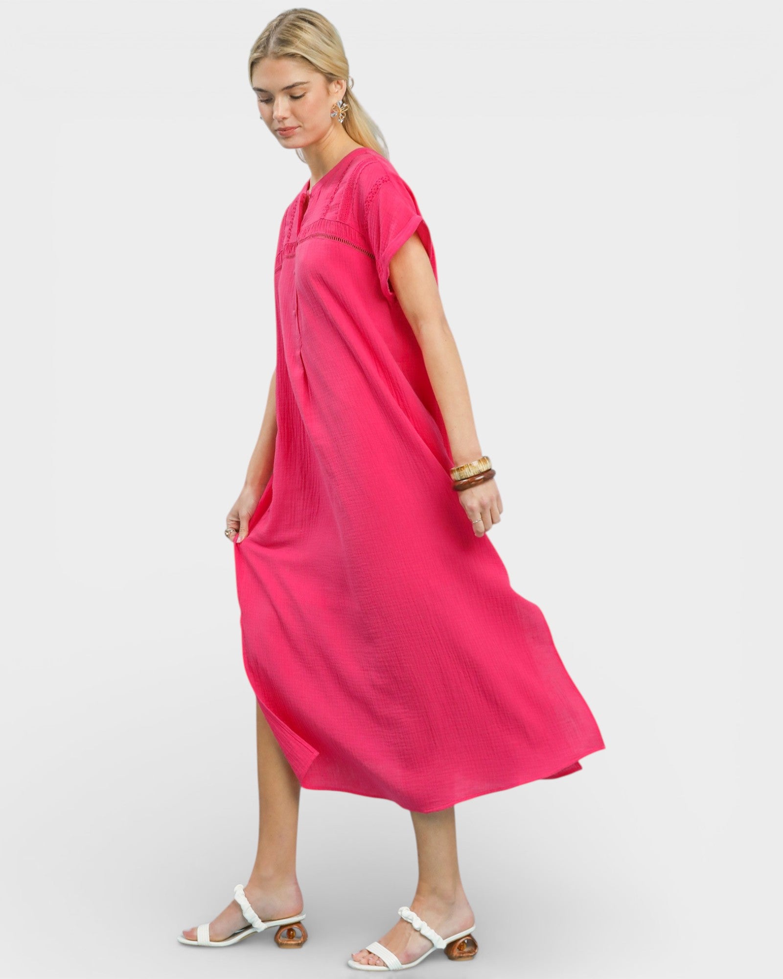 Woman wearing a bright pink dress on a white background