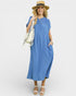 Woman wearing a blue dress with a white background