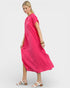 Woman wearing a bright pink dress on a white background