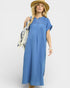 Woman wearing a blue dress and straw hat on a white background