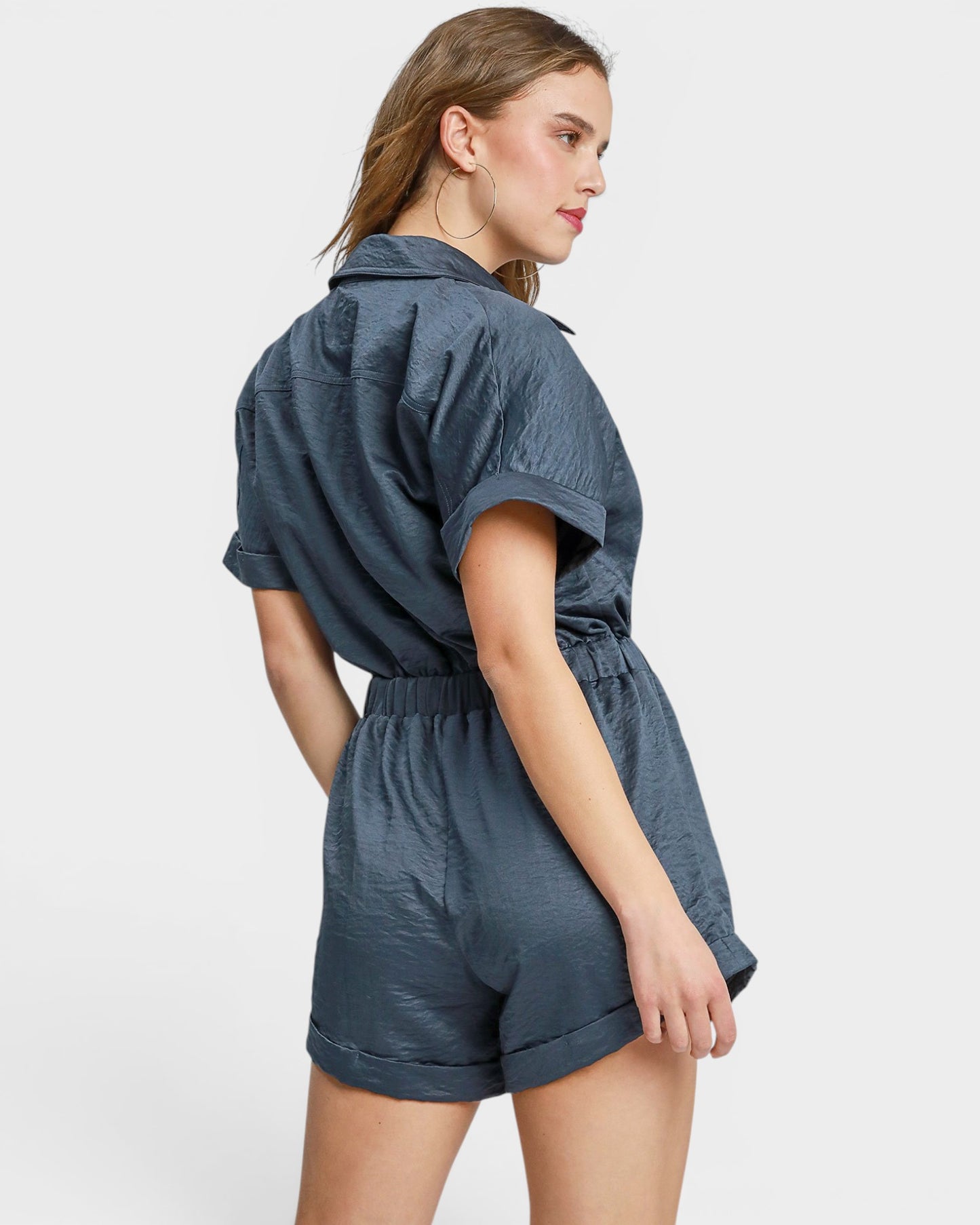 Woman wearing a blue romper on a white background