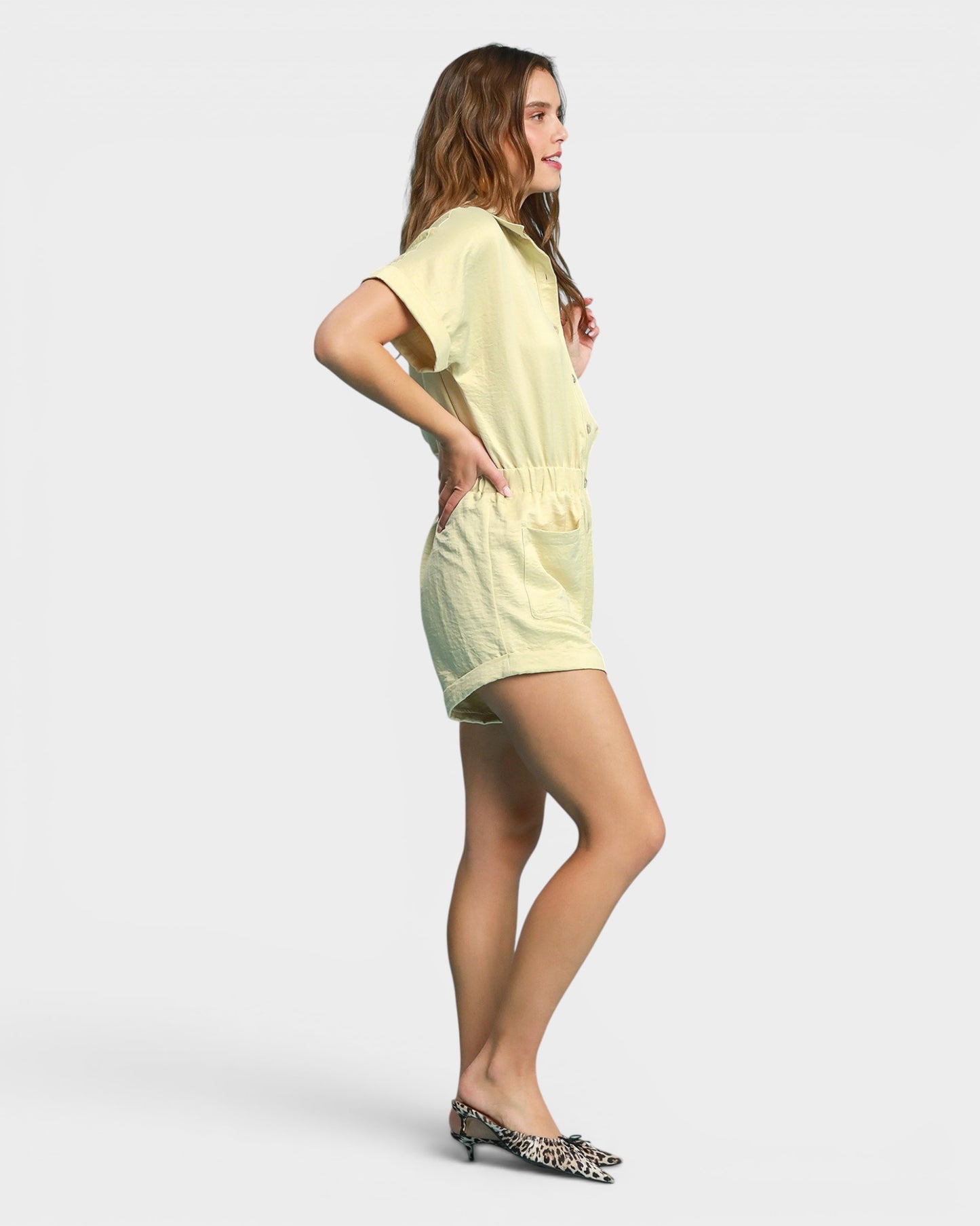 Woman wearing a light green outfit on a white background