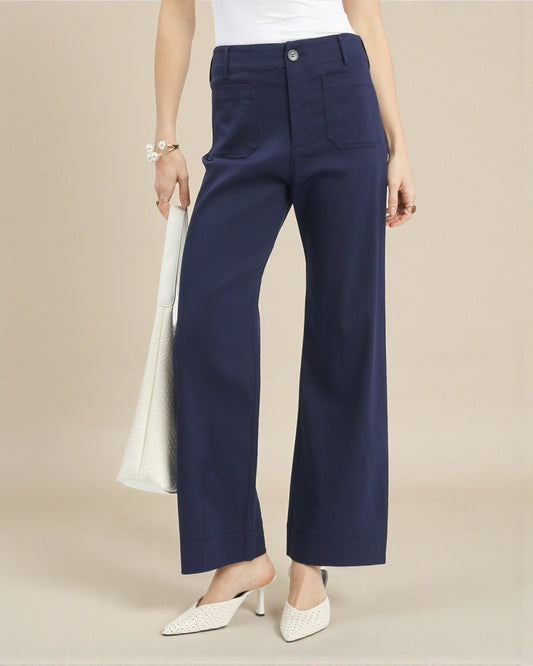 Navy blue pants worn by a person on a beige background