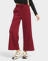 Red wide-leg pants worn by a person on a white background