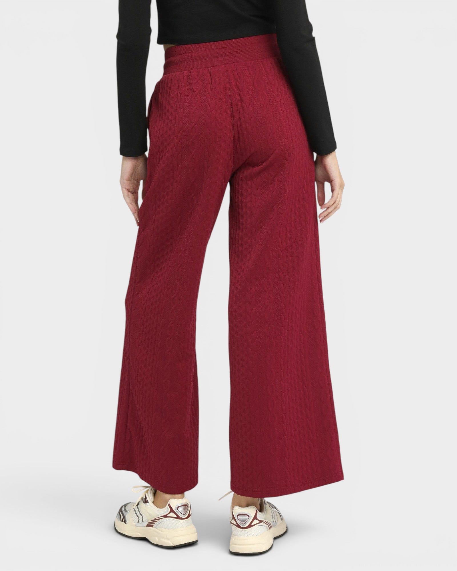 Red wide-leg pants worn by a person on a white background