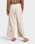 Person wearing beige textured pants on a white background