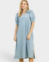 Woman wearing a light blue dress with puff sleeves on a white background
