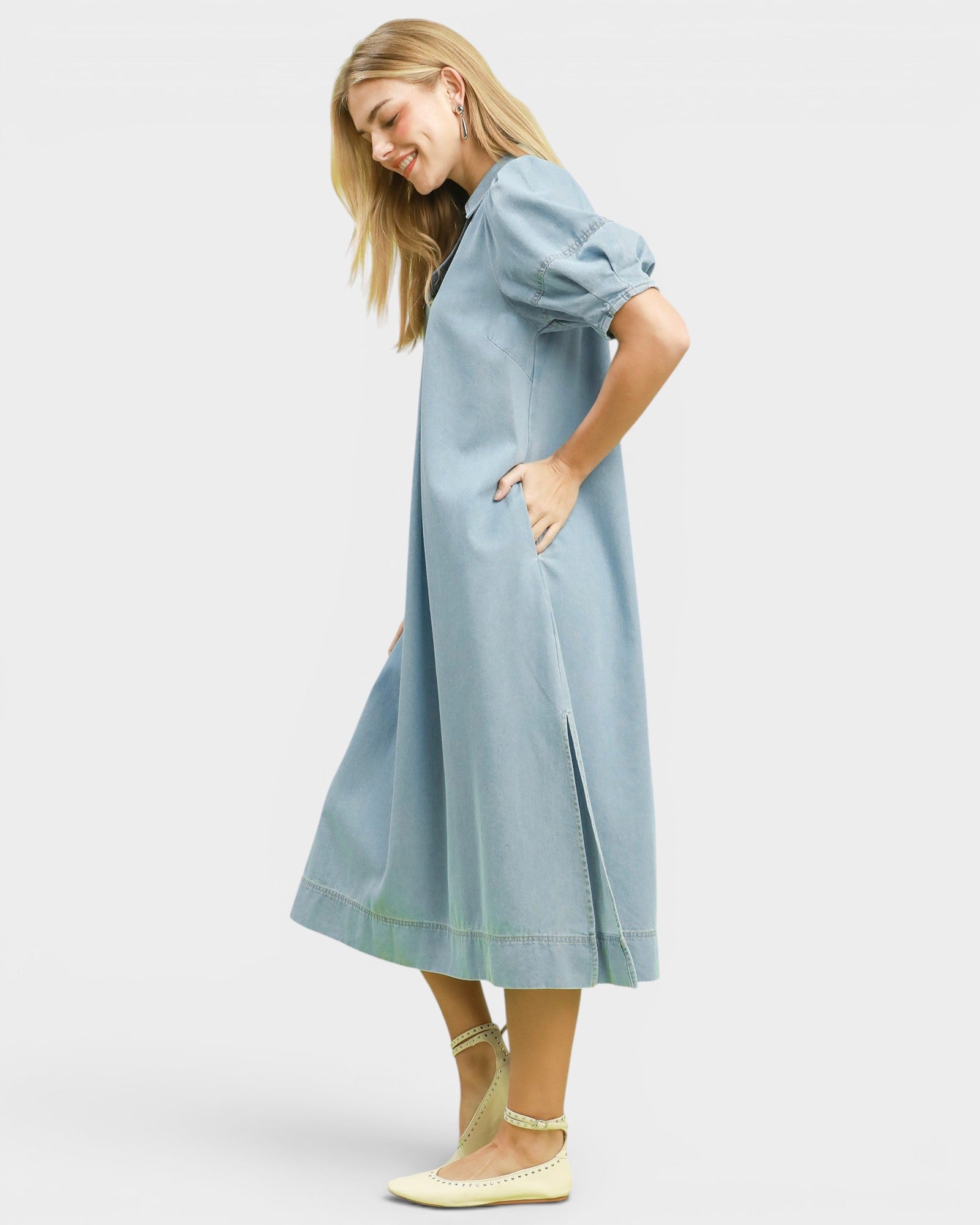 Woman wearing a light blue dress on a white background