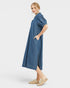 Woman wearing a blue denim dress on a white background