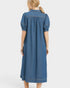 Blue denim dress worn by a person on a white background