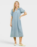 Woman wearing a light blue dress on a white background