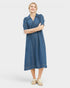 Woman wearing a blue dress with short sleeves on a white background