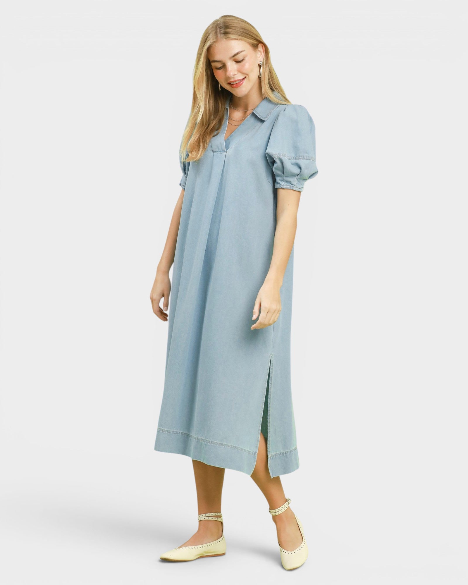 Woman wearing a light blue dress on a white background