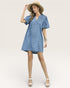 Woman wearing a blue dress and straw hat on a white background