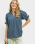 Woman wearing a blue blouse with short sleeves on a white background