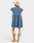 Woman wearing a blue striped dress with a beige hat and boots on a white background
