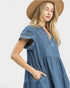 Woman wearing a blue striped dress and tan hat on a white background