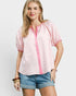 Woman wearing a pink checkered shirt and denim shorts on a white background