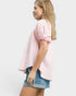 Woman wearing a pink checkered shirt and denim shorts on a white background
