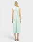 Woman wearing a light green striped dress on a white background