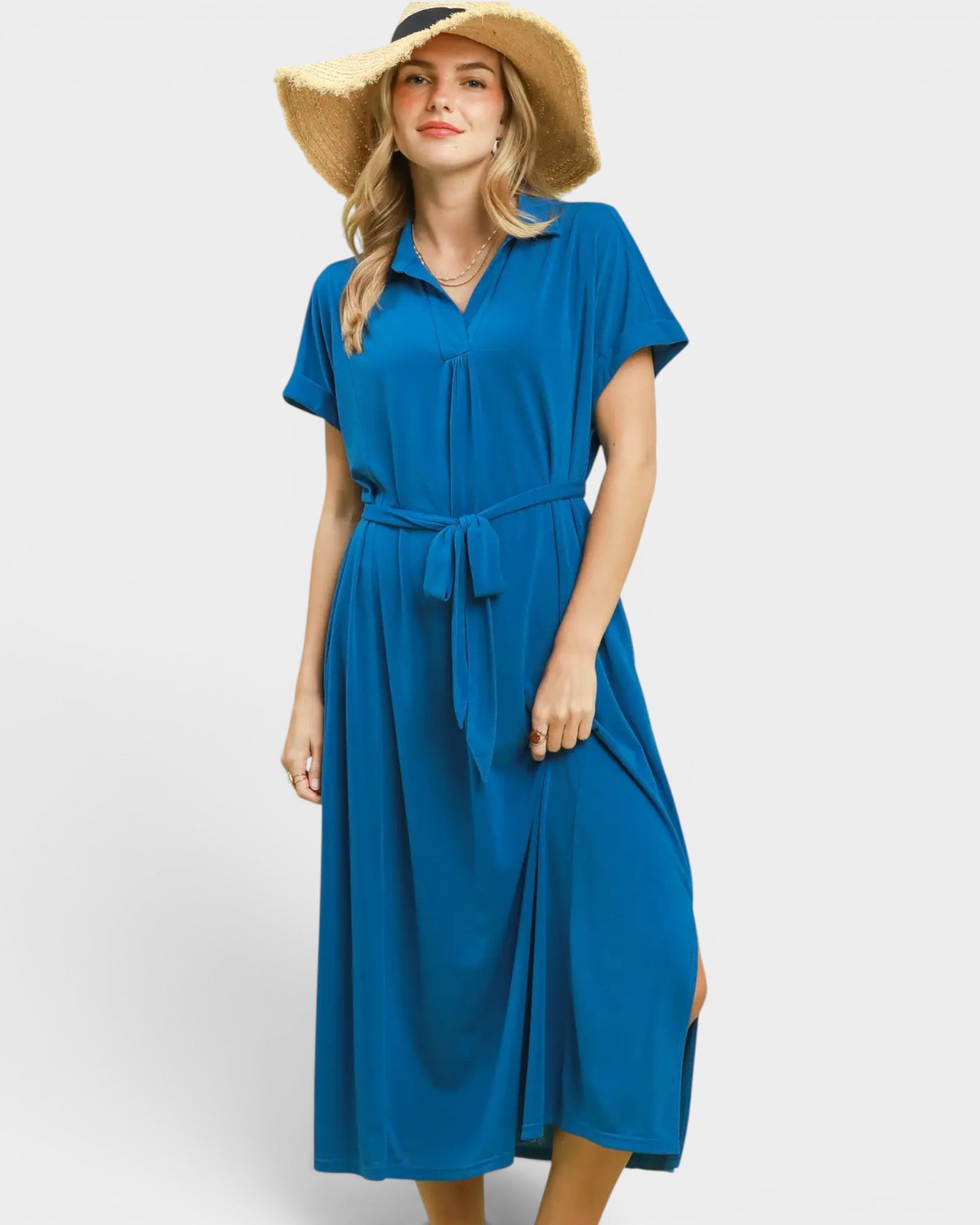 Woman wearing a blue dress with a belt on a white background