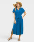 Woman wearing a blue dress and wide-brimmed hat on a white background