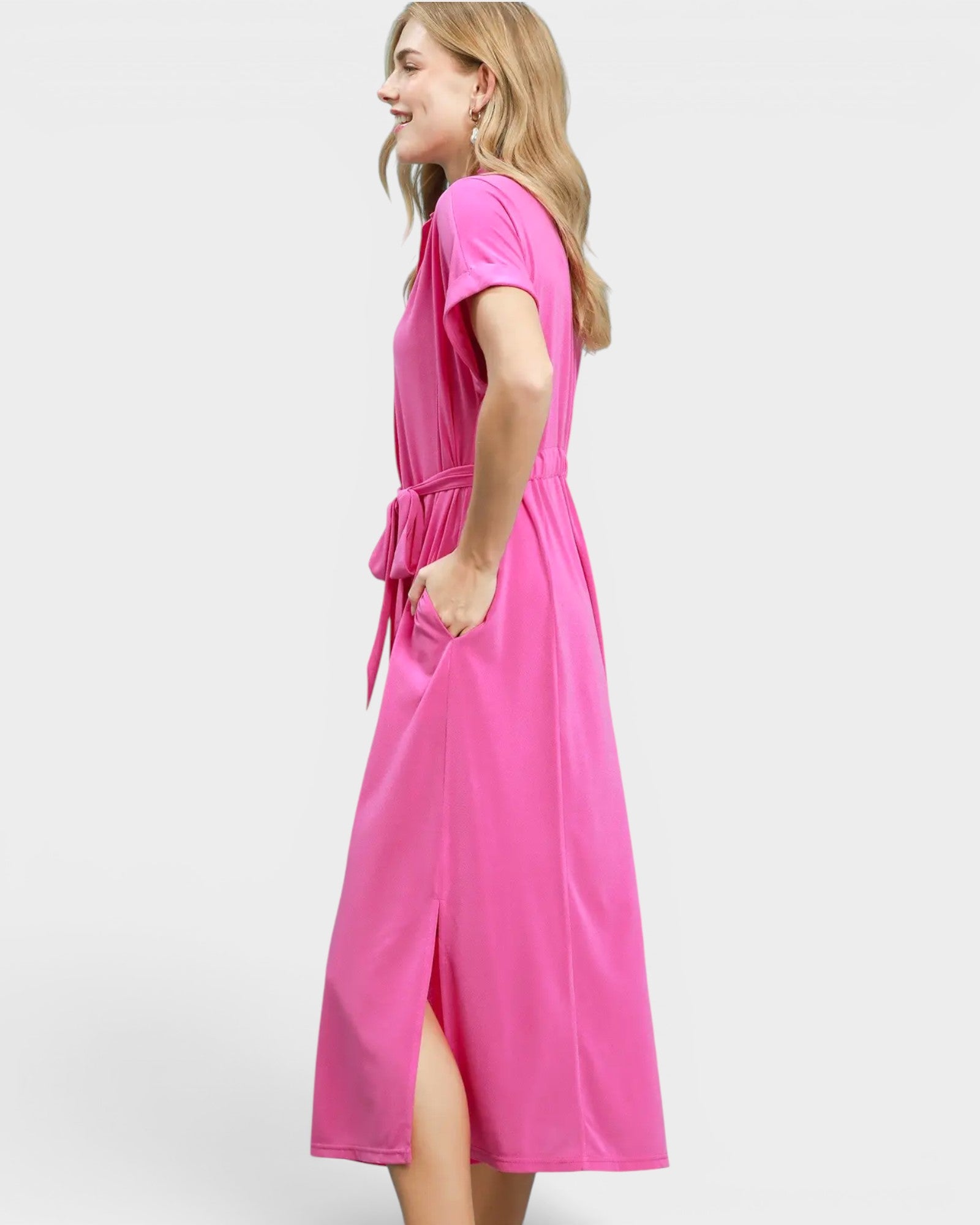 Woman wearing a bright pink dress on a white background