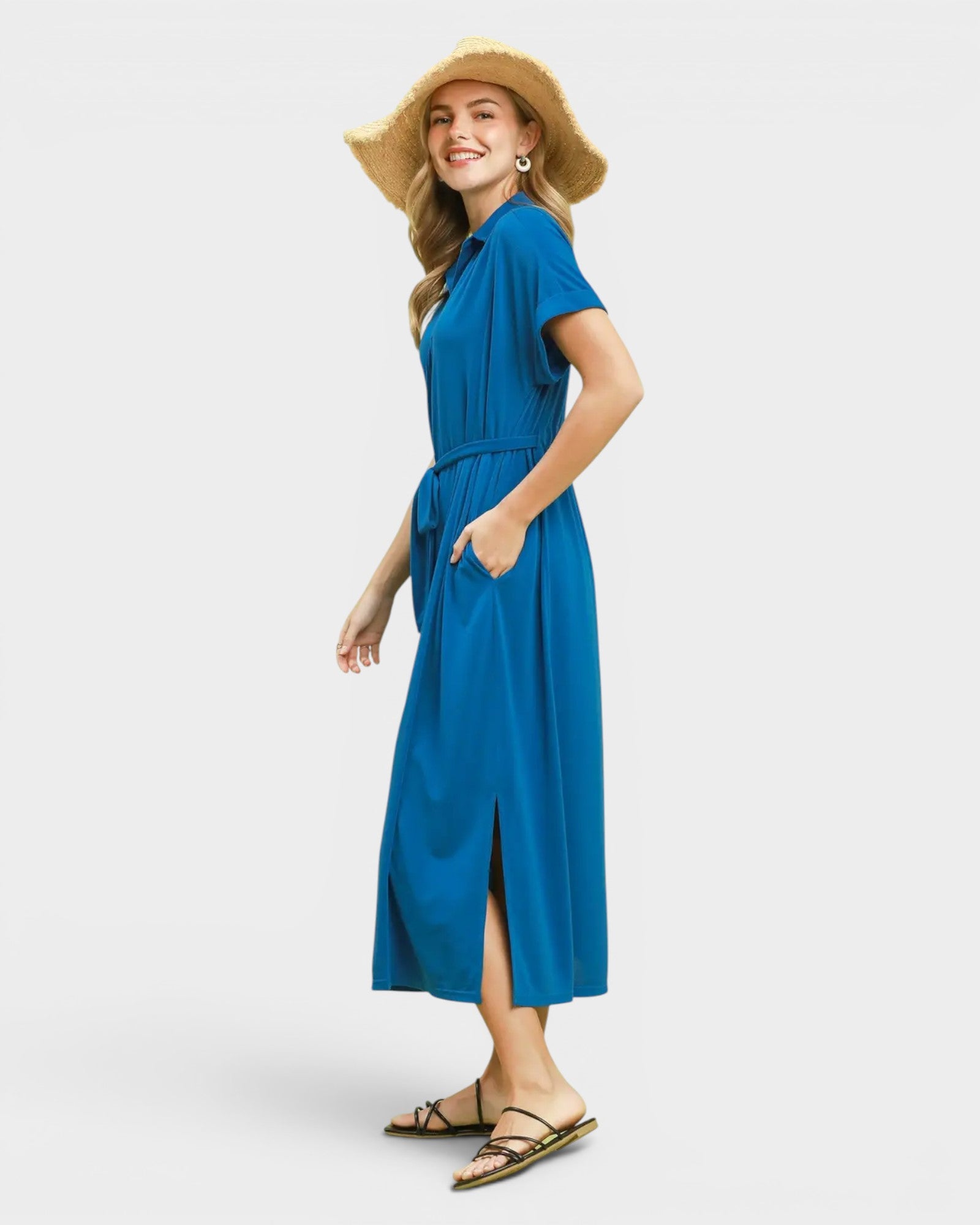 Woman wearing a blue dress and straw hat on a white background