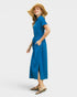 Woman wearing a blue dress and straw hat on a white background