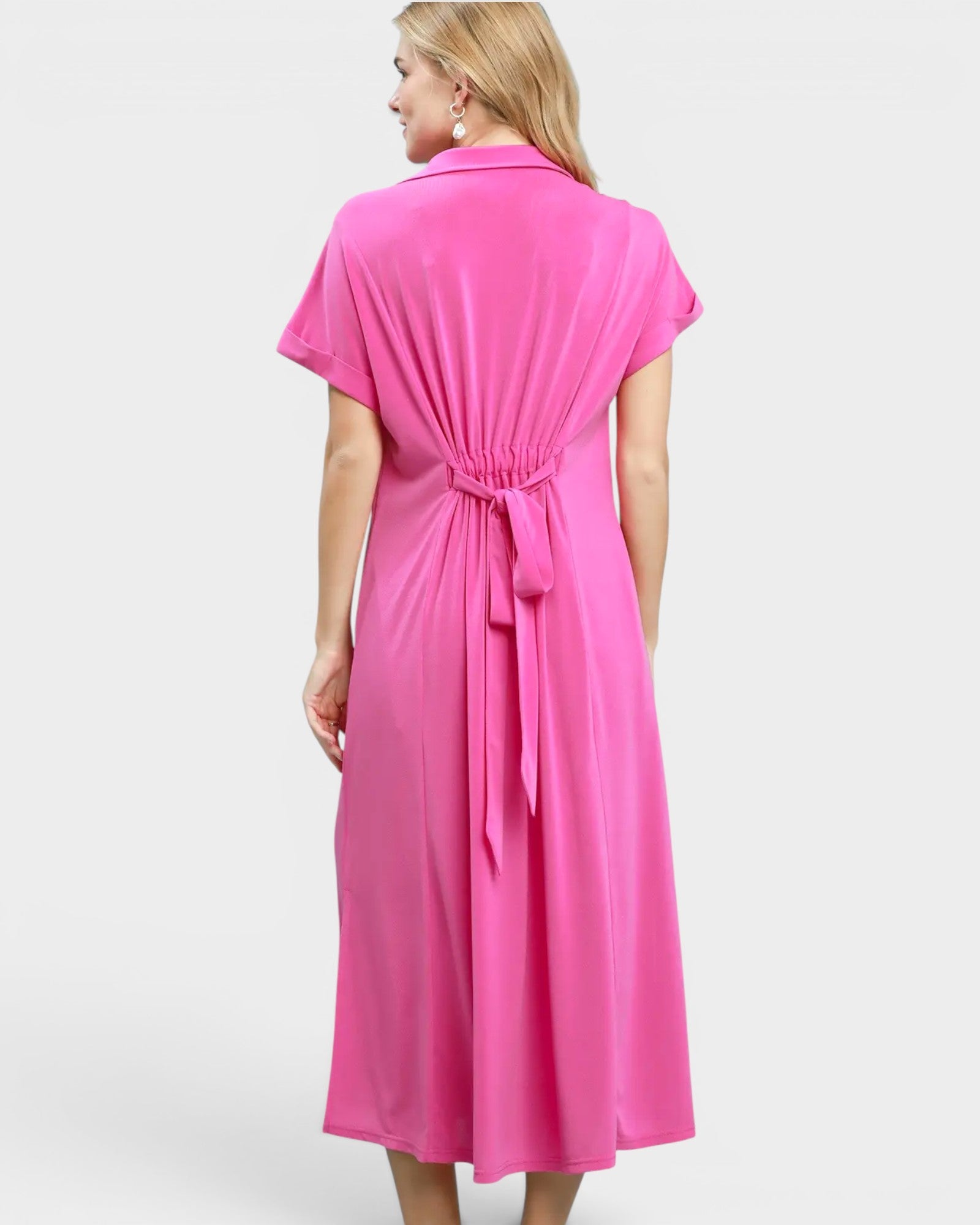Woman wearing a pink dress on a white background
