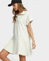 Woman wearing a white dress with a black cap on a plain background
