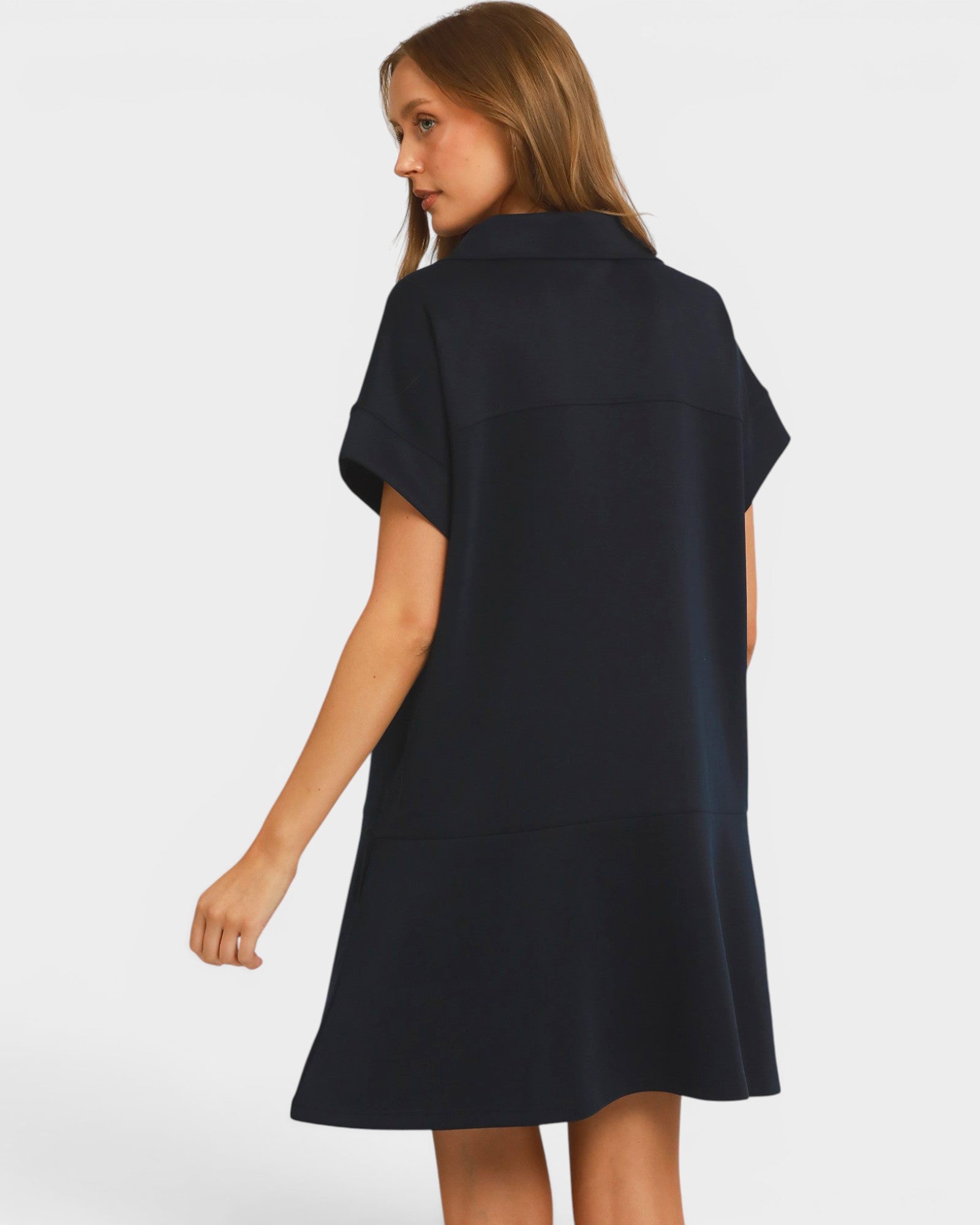 Woman wearing a black dress against a white background